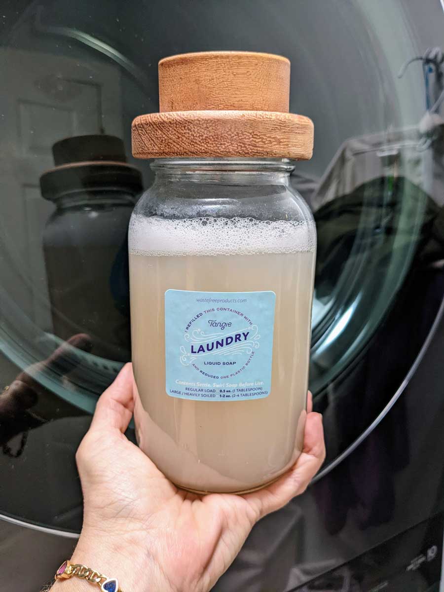 Tangie Laundry Liquid Soap Concentrate in mason jar with laundry sticker label. Plastic-free laundry concentrate made in America, dissolves to create powerful liquid detergent.