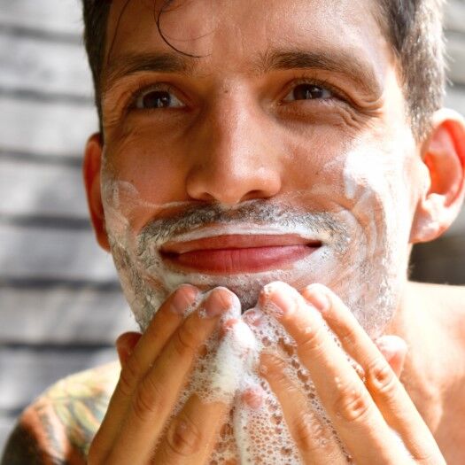 Man lathering face with Tangie Shave Bar for a clean, eco-friendly shave.