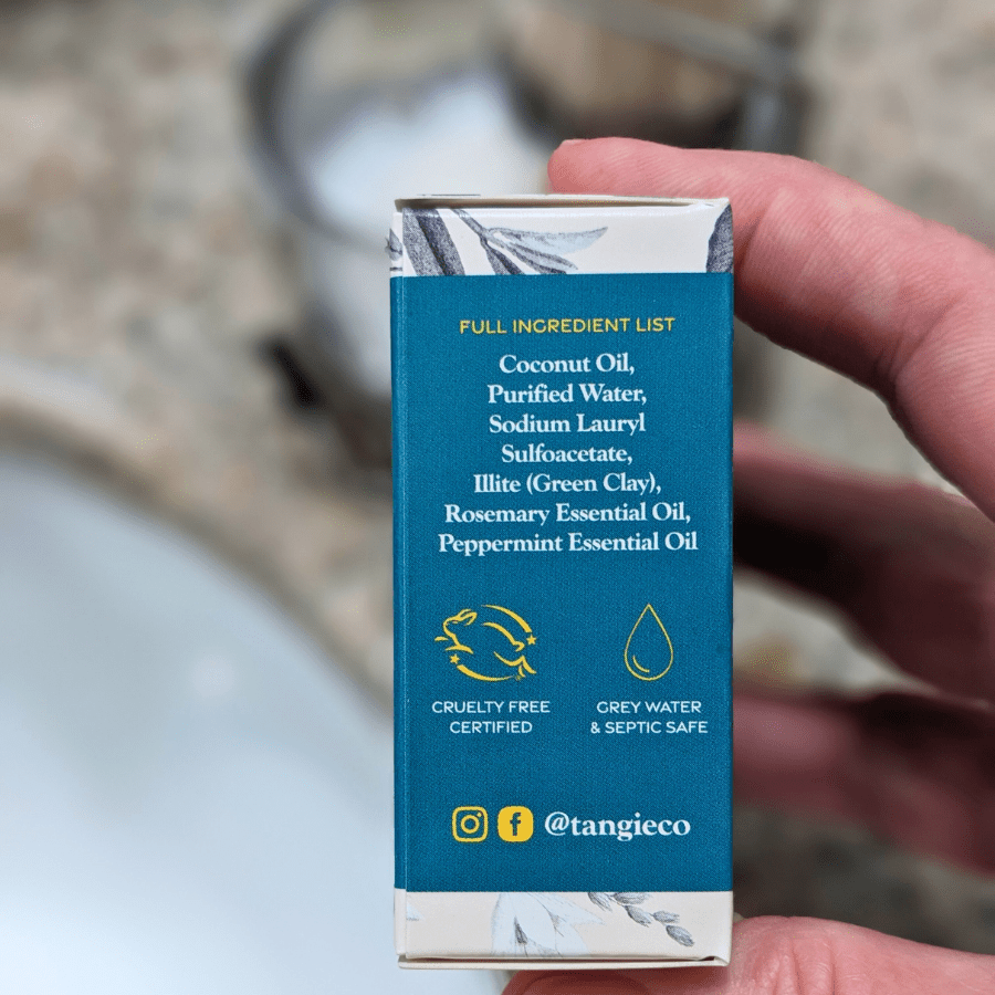 Side panel of Tangie’s Rosemary Mint Shave Cream Bar packaging displaying the ingredient list, including coconut oil, purified water, and essential oils.