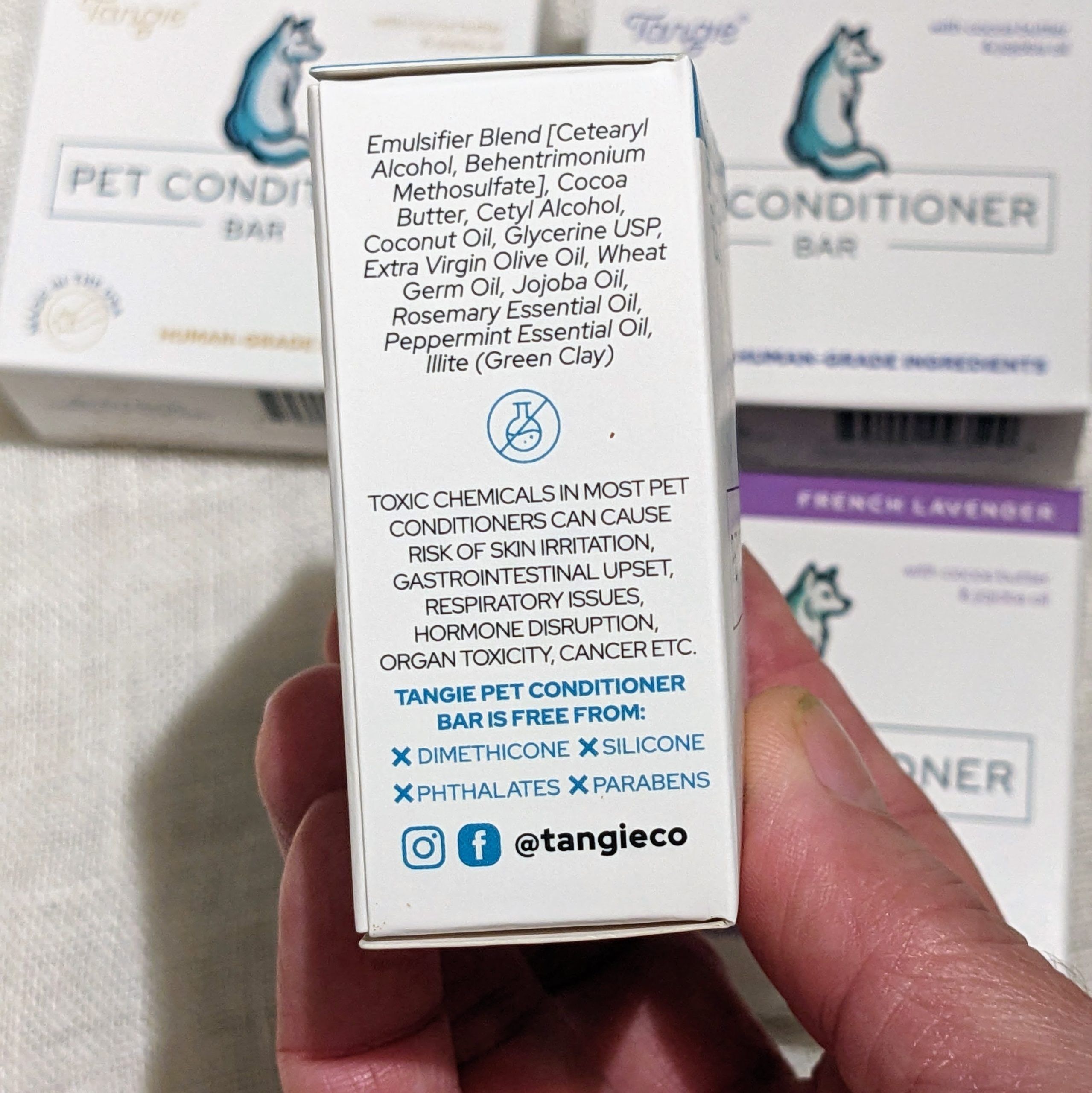 Side panel of Tangie Pet Conditioner Bar showing ingredient list and highlighting what is not included, like parabens and phthalates.