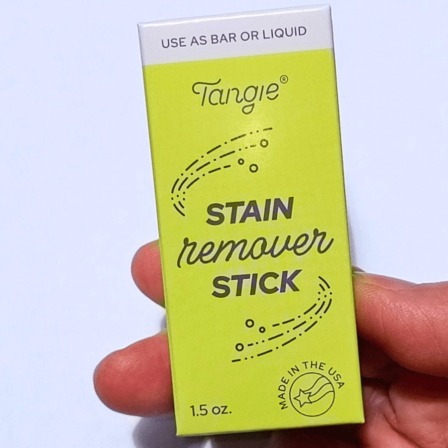 Tangie Laundry Stain Remover Bar in hand with eco-friendly packaging