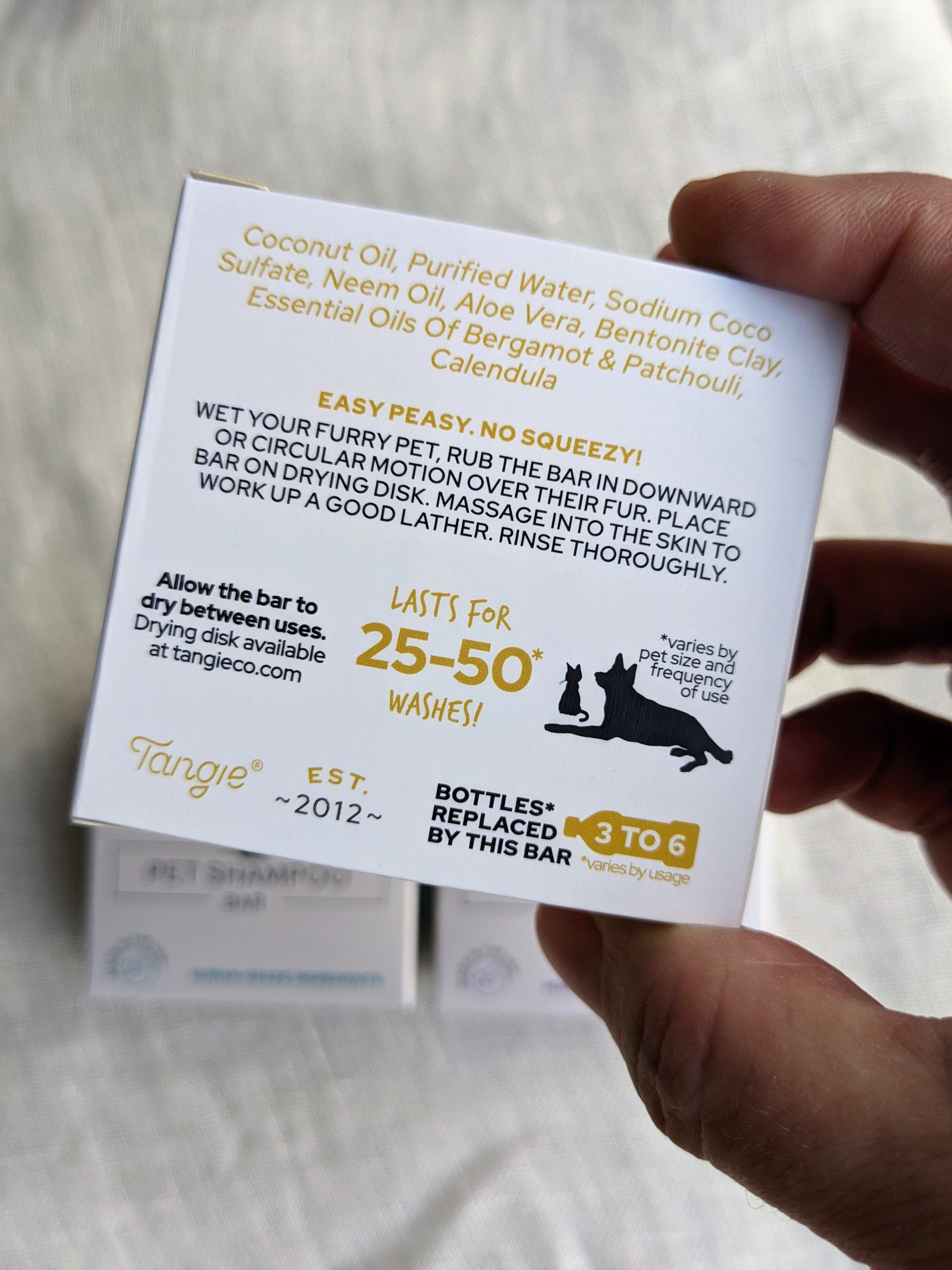 Bergamot and patchouli pet shampoo bar by Tangie, moisturizing and earthy, with calendula for added nourishment.