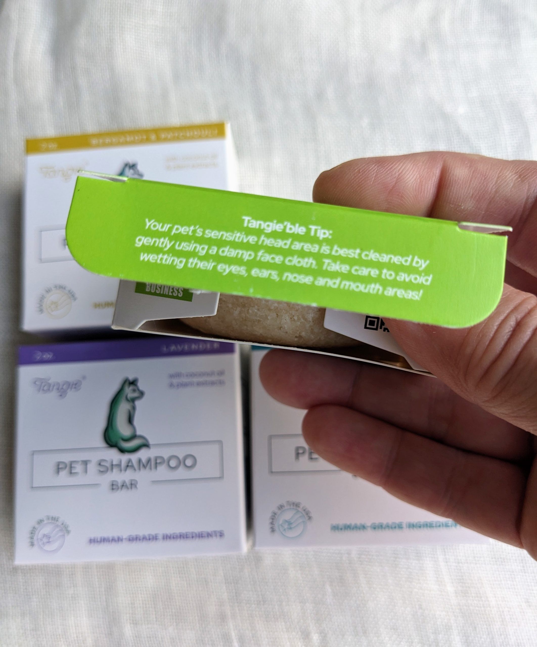 Tangie Pet Shampoo Bar box featuring a Tangie’ble Tip on the flap, offering advice for gently cleaning your pet's sensitive head area.