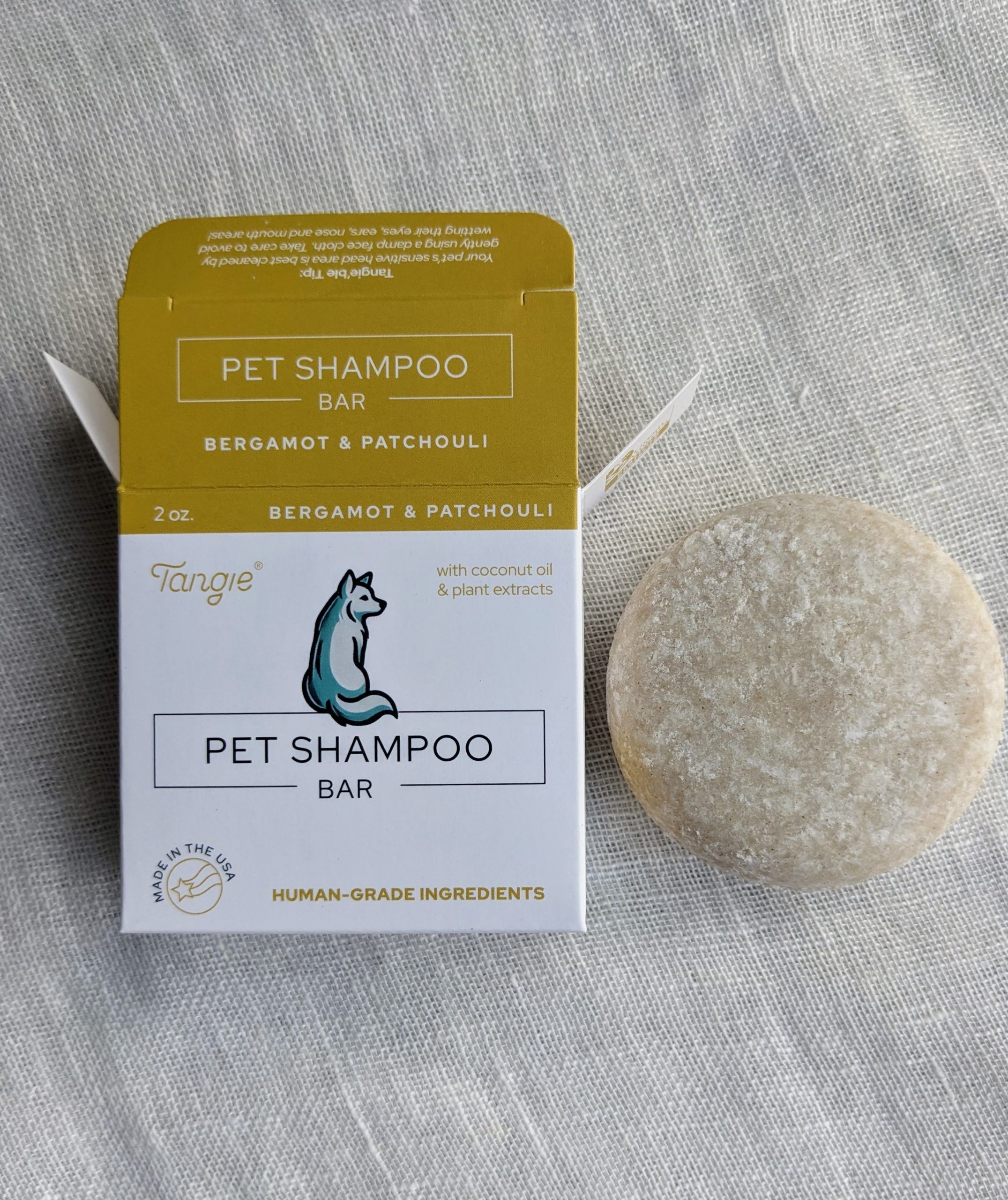 Bergamot and patchouli pet shampoo bar by Tangie, moisturizing and earthy, with calendula for added nourishment.
