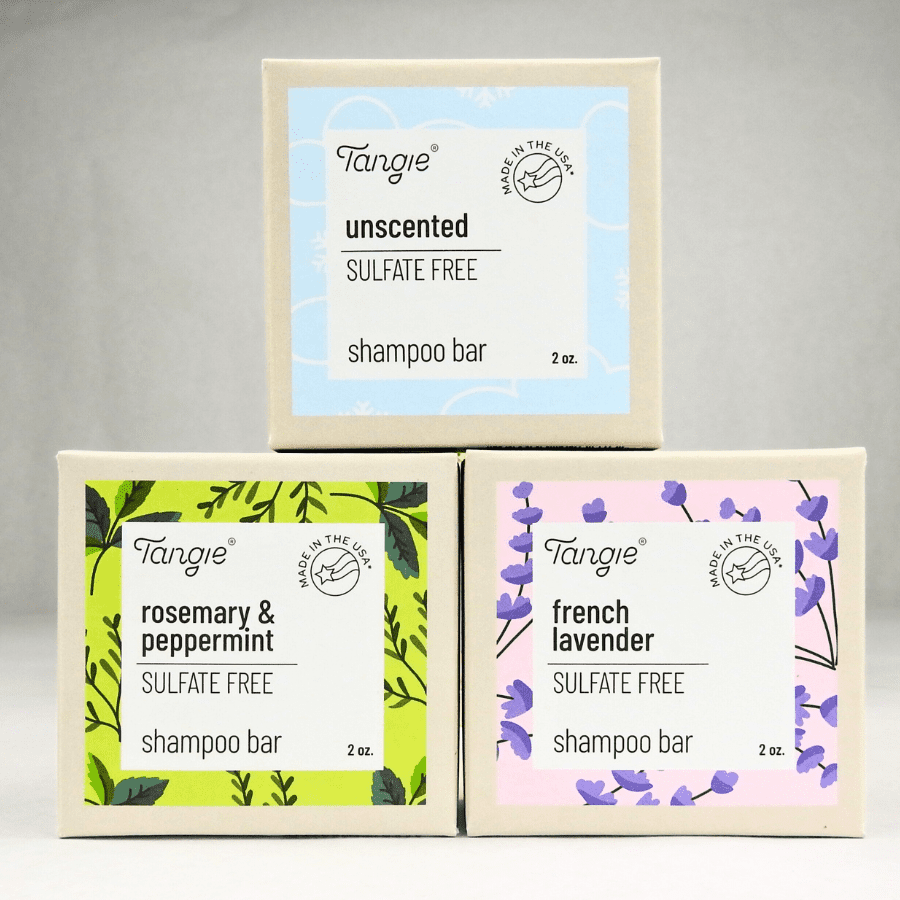 Tangie shampoo bars in unscented, rosemary mint, and lavender stacked in a pyramid