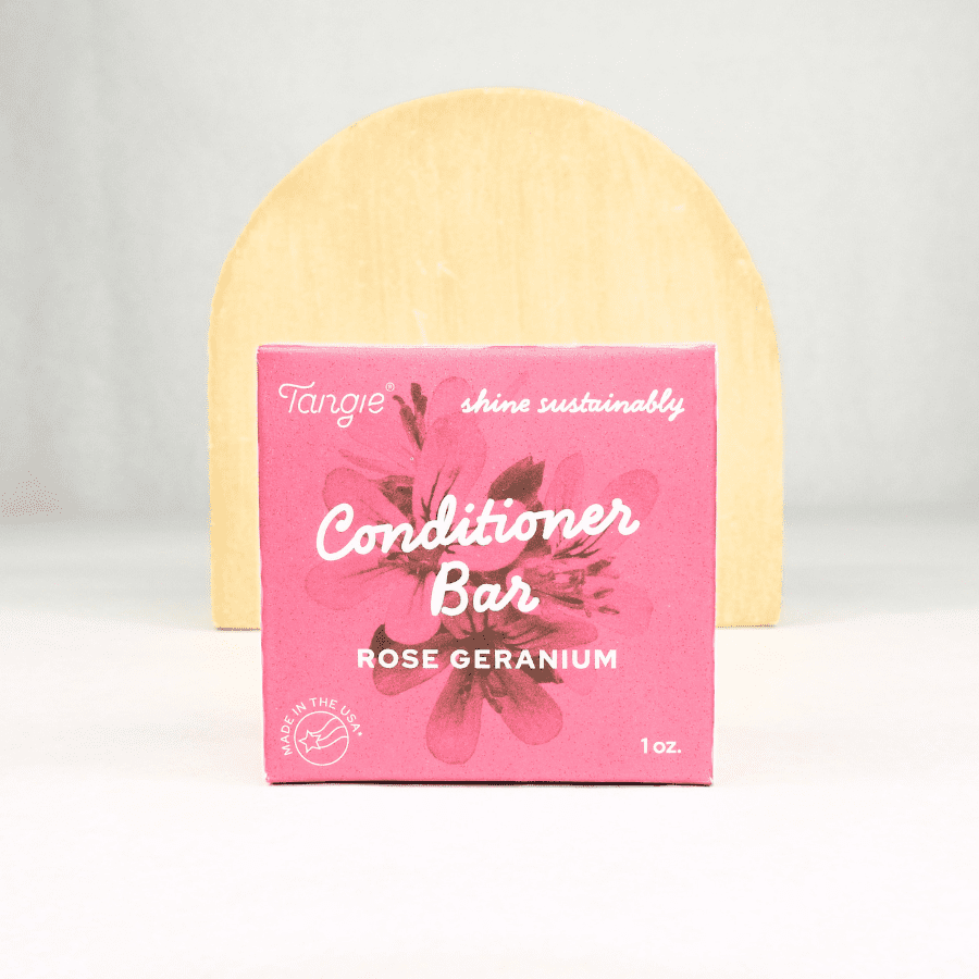 Rose Geranium Conditioner Bar by Tangie in pink box with wood background. Plastic-free solid conditioner for dry, itchy, or sensitive scalps.