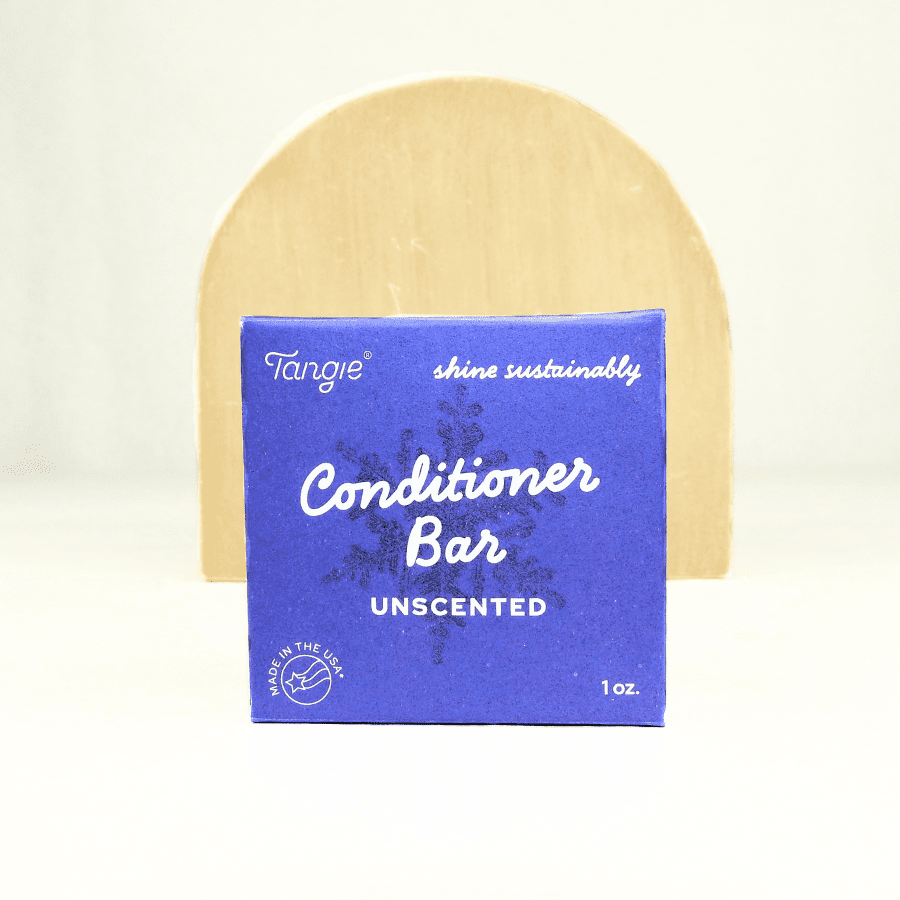 Tangie Unscented Conditioner Bar in recyclable paper box packaging, displayed upright on natural wood background.