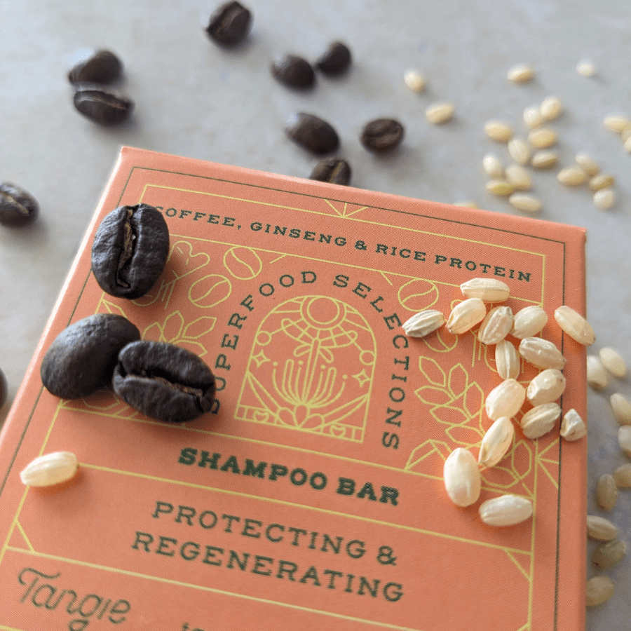 Hand holding Tangie Superfoods Shampoo Bar with natural ingredients displayed, showcasing plastic-free packaging and eco-friendly design.