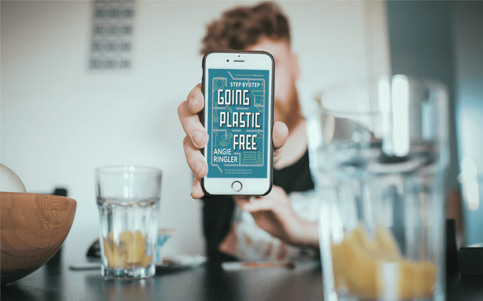 Going Plastic Free: Room by Room eBook (2026 edition) displayed on a smartphone held in hand.