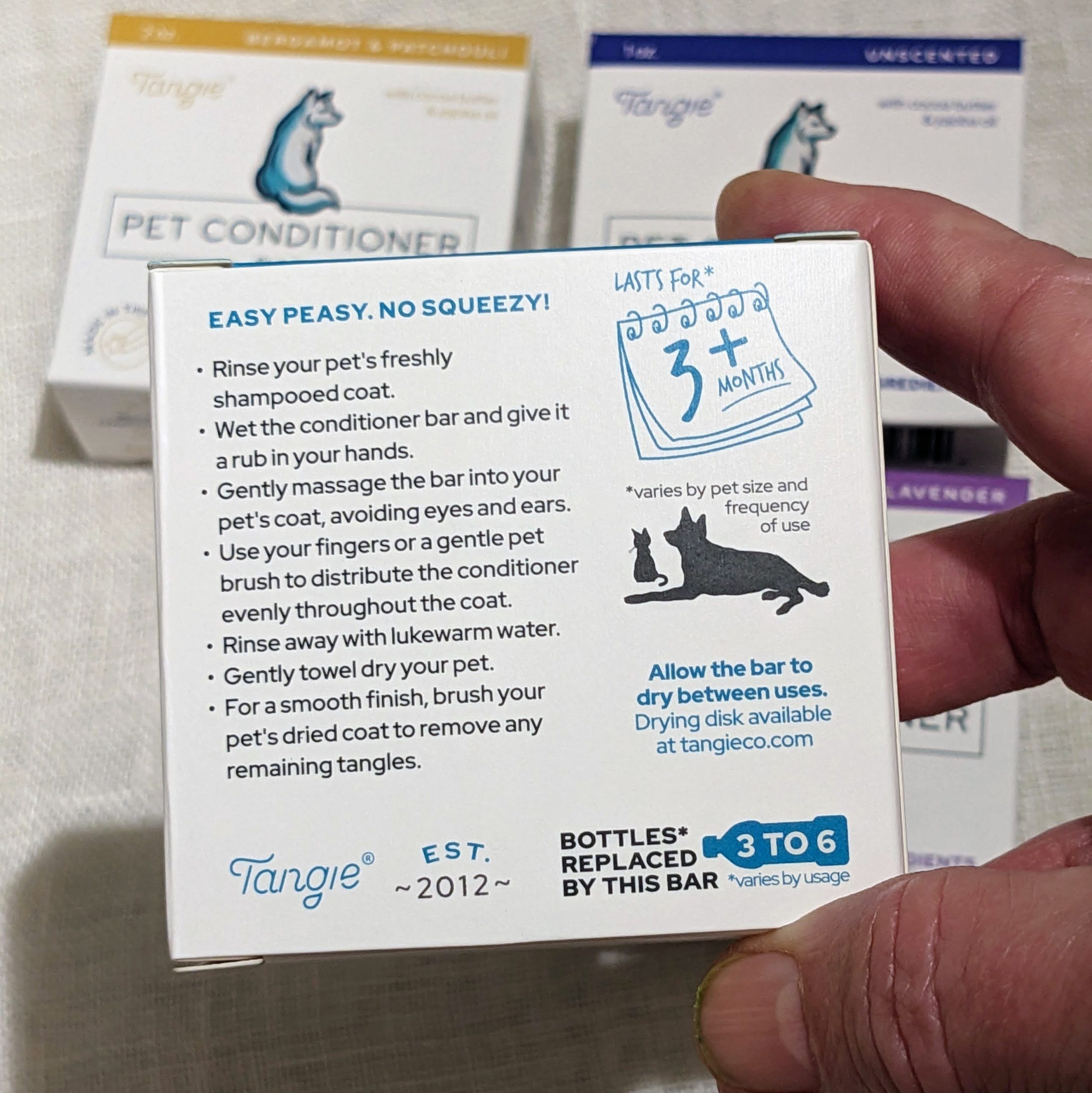 Close-up of Tangie Pet Conditioner Bar back panel with detailed instructions, durability, and eco-friendly storage tips.